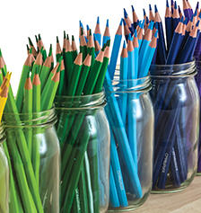Coloured pencils in glass jars.